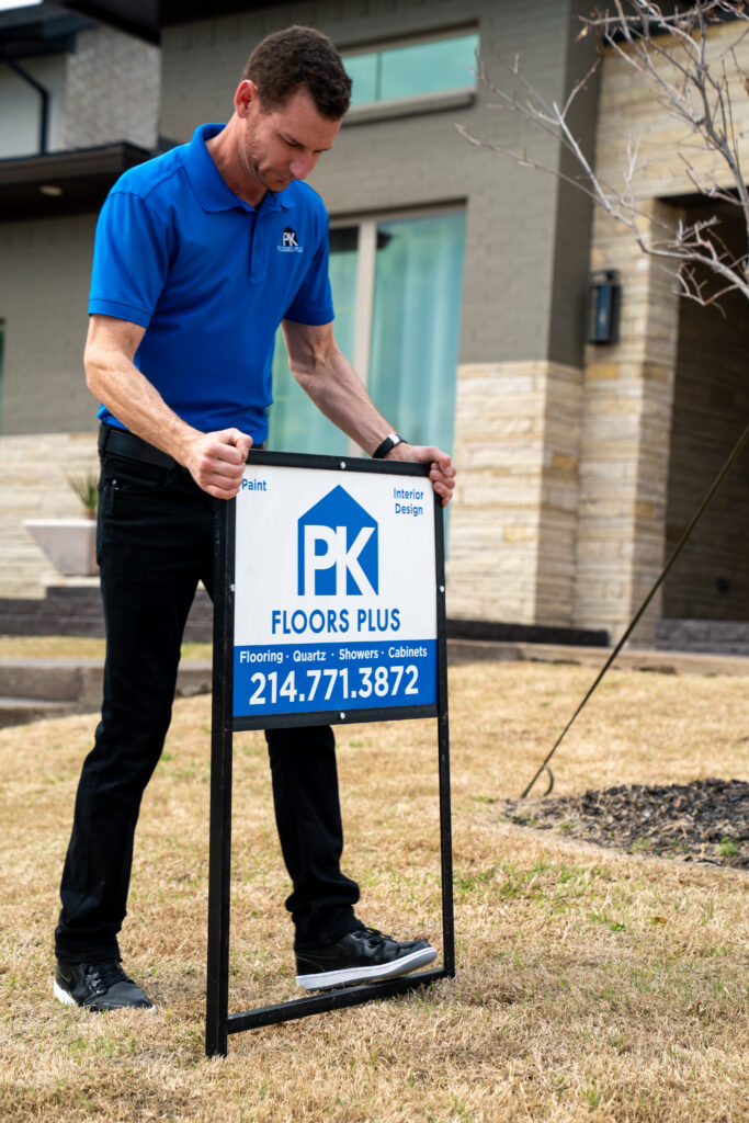 Heath Texas Remodel Pro Installing his sign for PK Floors Plus